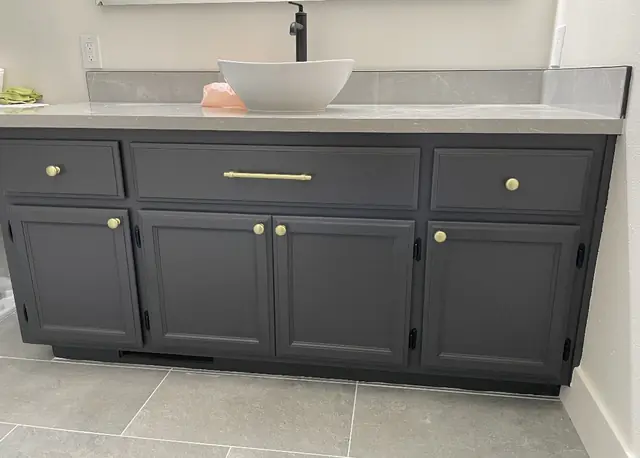 Bathroom vanity refinished in charcoal with brass pulls