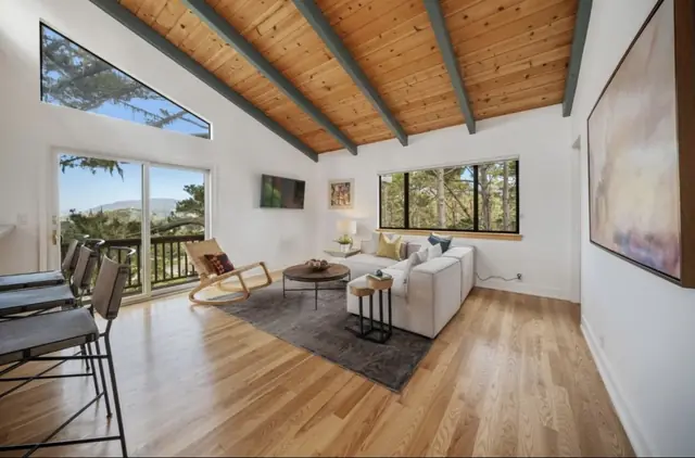 Bright living room under a stained wood ceiling