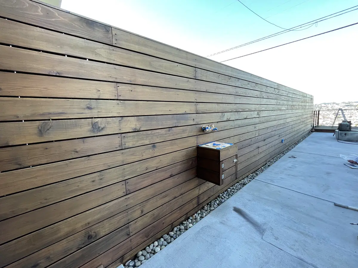Long horizontal wood fence with a fresh stain