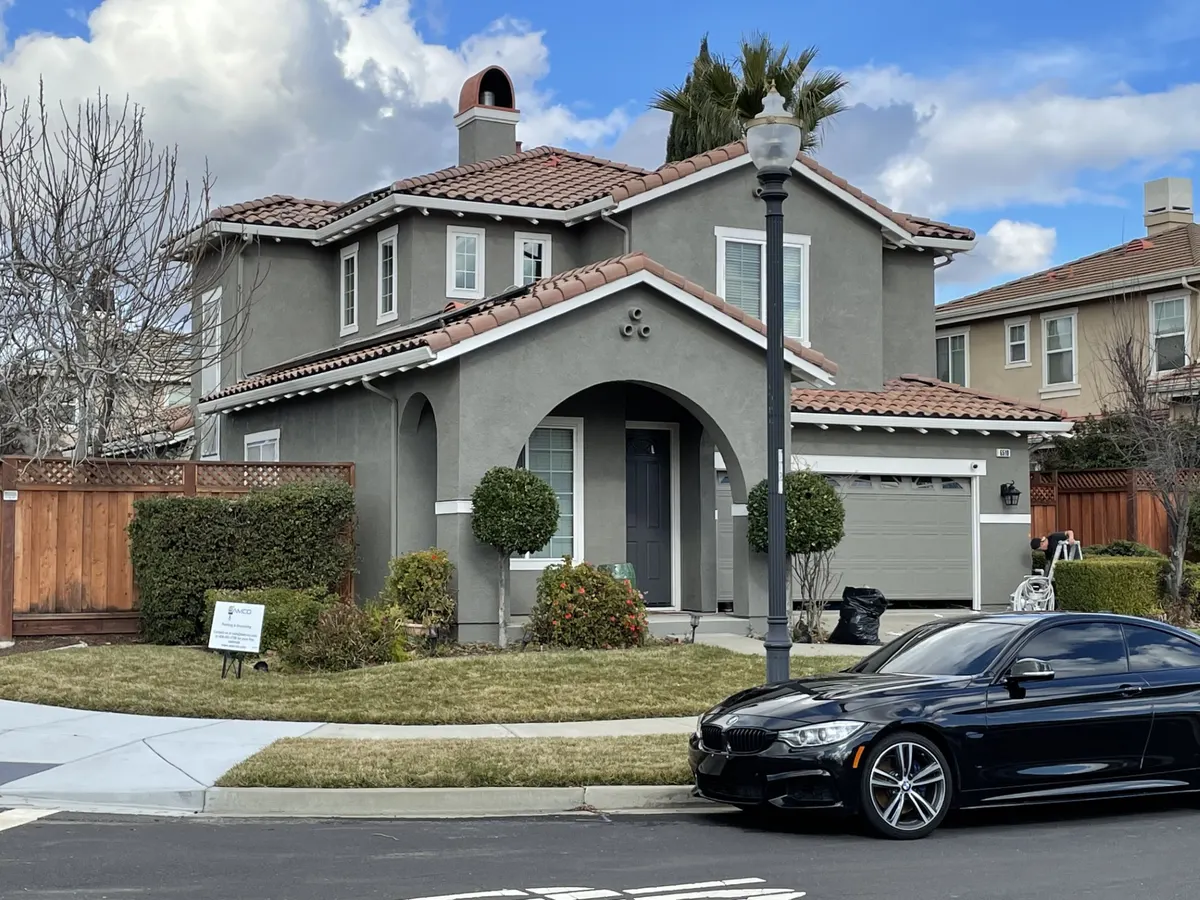 Two-story craftsman home painted gray with white trim