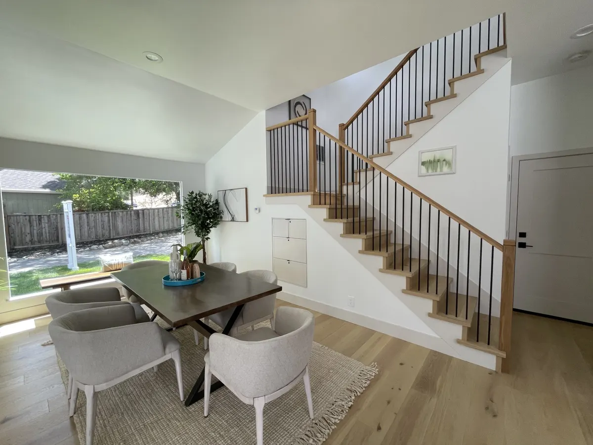 Staircase with a stained wood handrail and black metal balusters