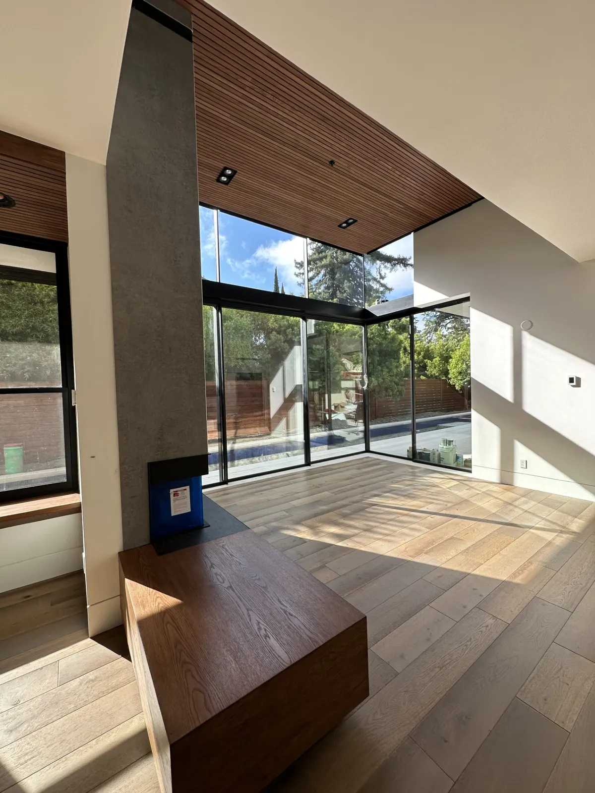 Interior with stained wood slat ceiling and wood-trimmed openings